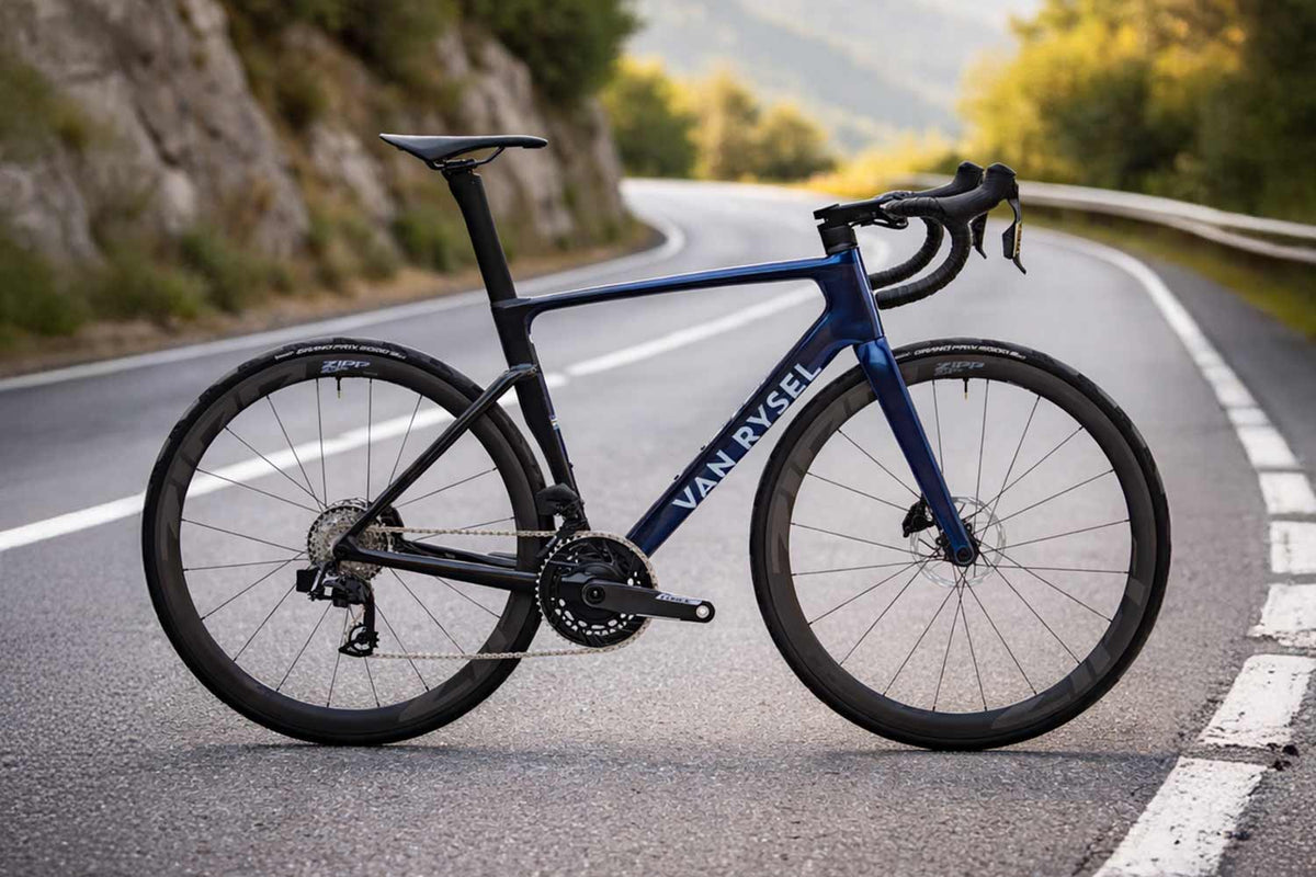 Van Rysel bicycle on a road with mountains in the background