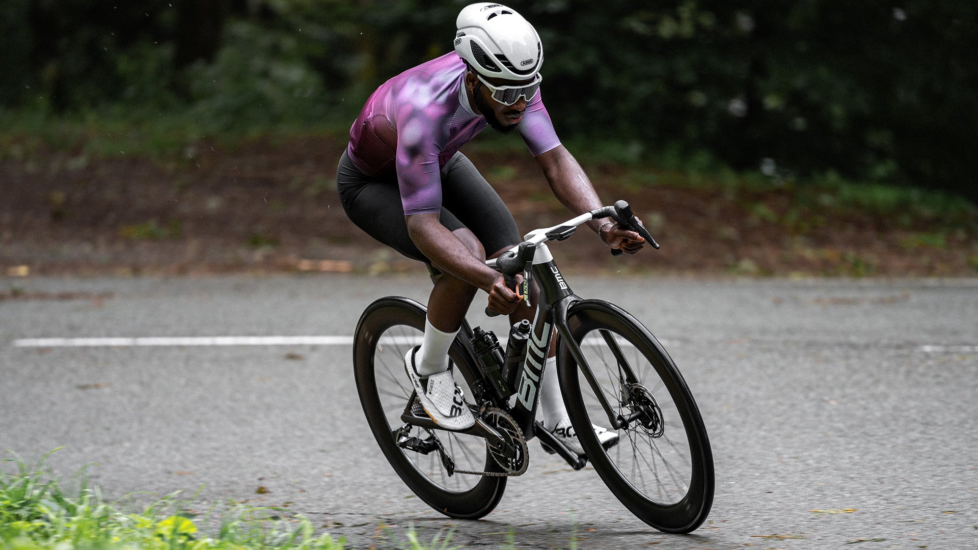 A man riding a BMC Teammachine R on a cobblestone road. 