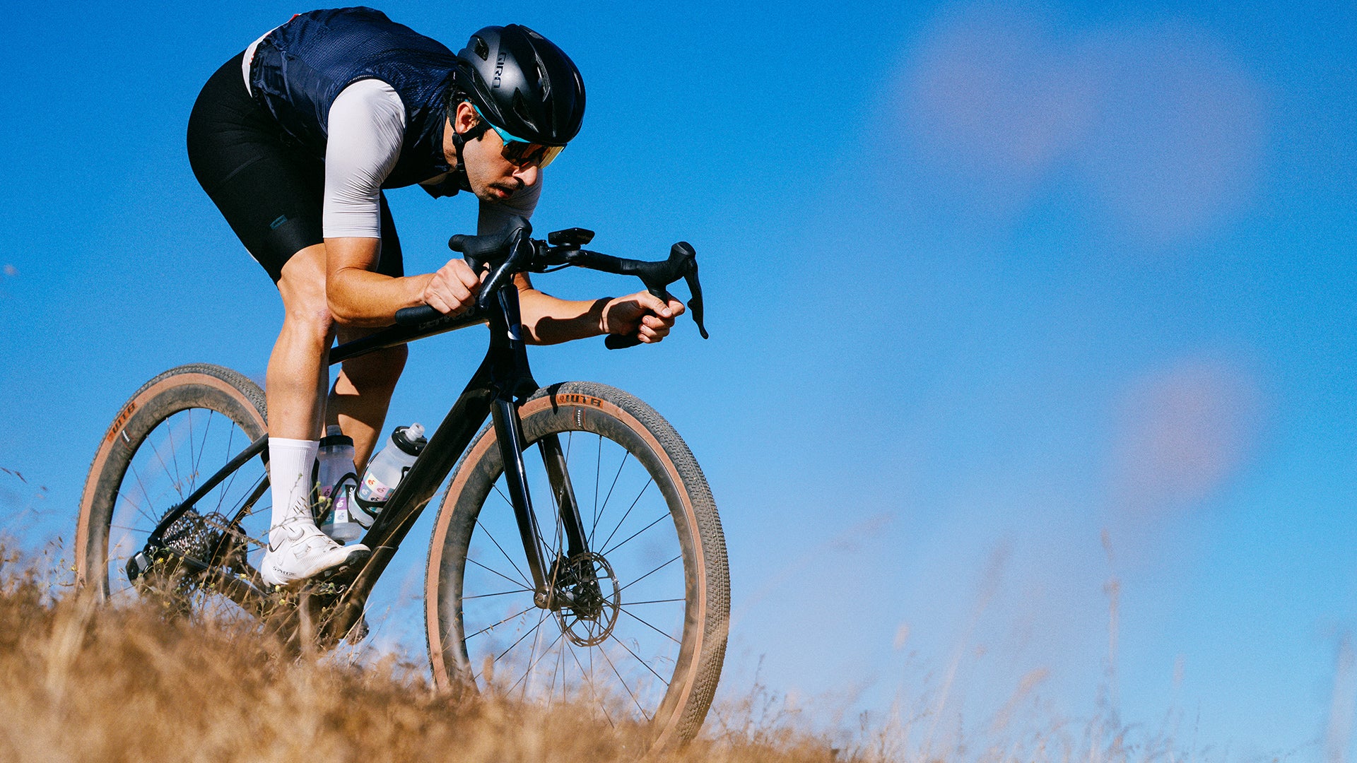 A man riding a cervelo aspero gravel bike down a hill