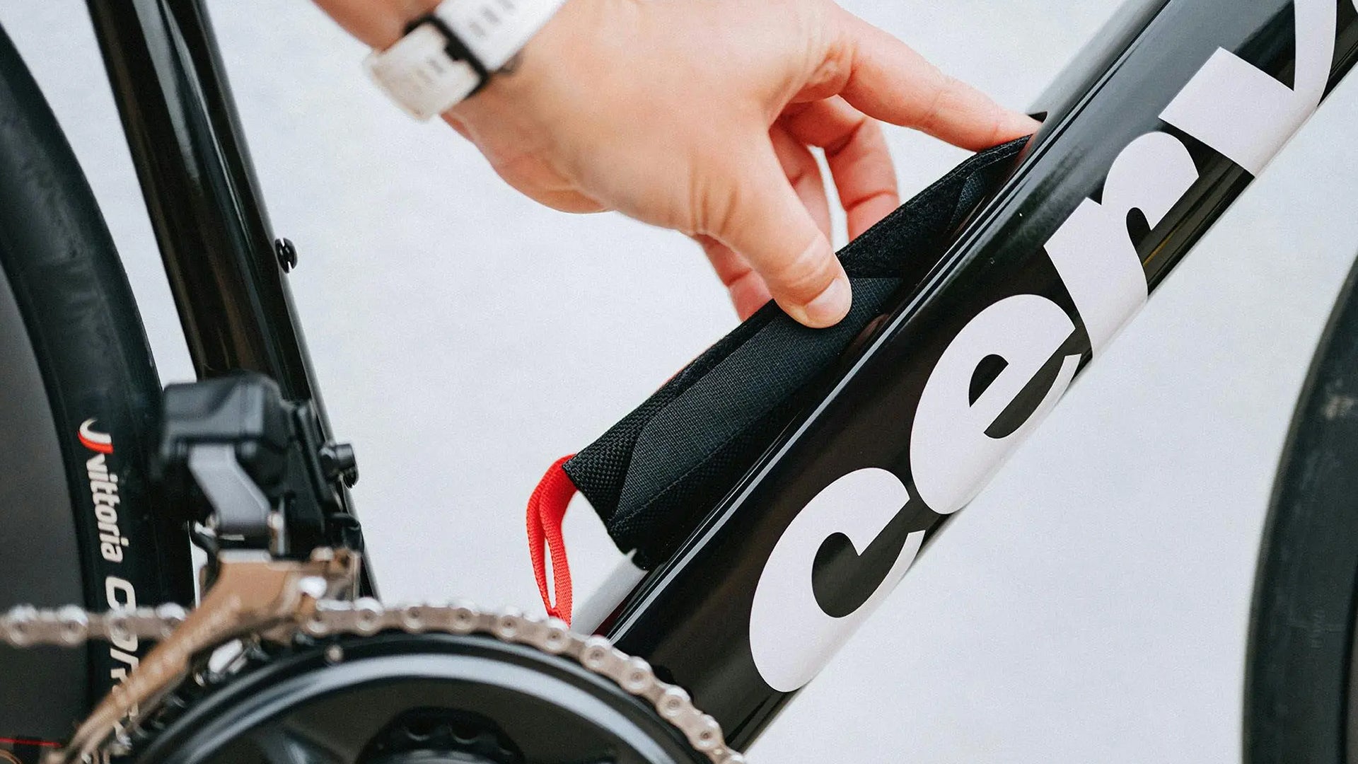 a person accessing the in frame storage of  cervelo caledonia 5 road bike 