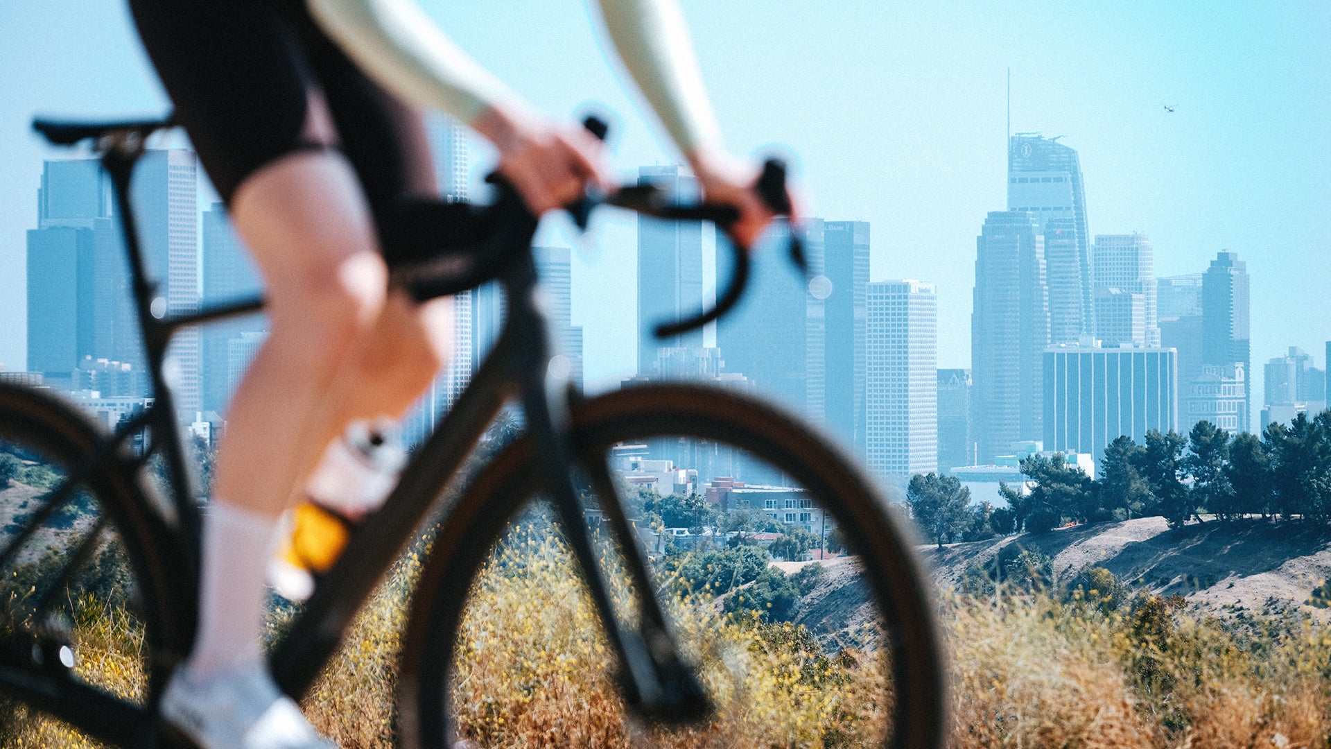 A man riding the cervelo rouvida bike with a city skyline in the background
