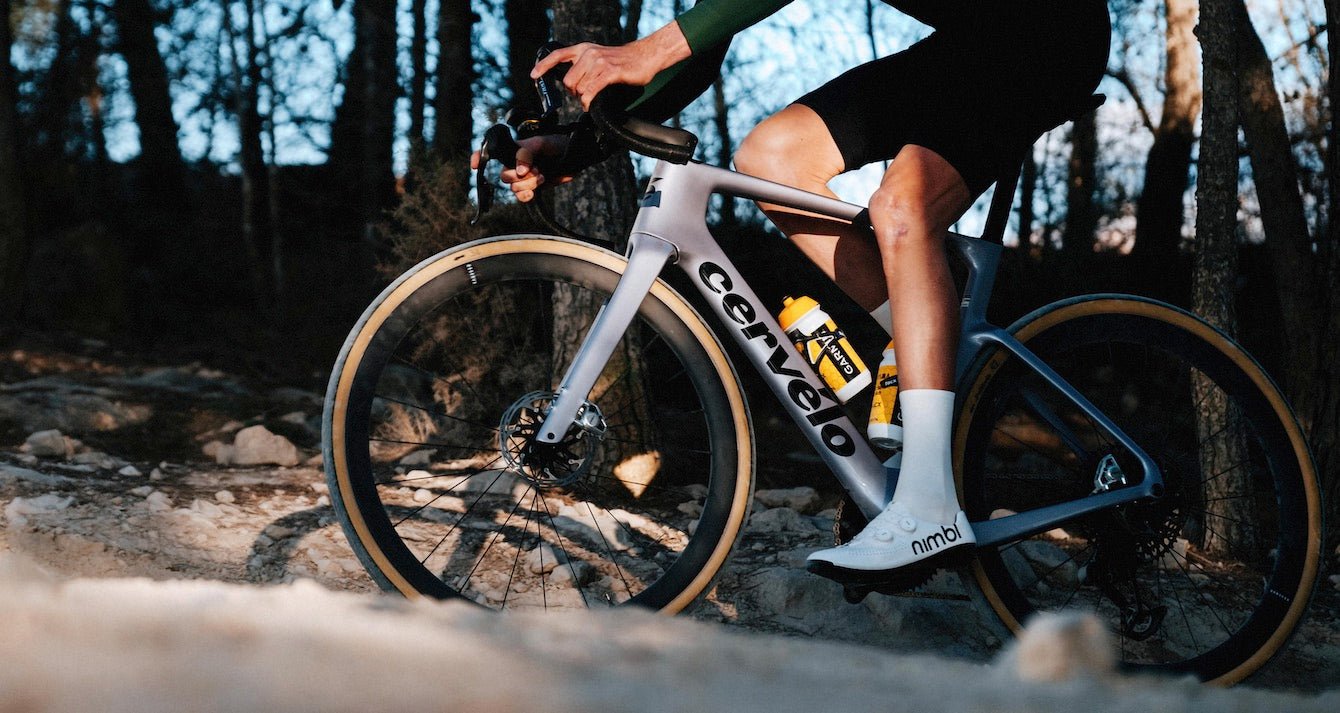 A person riding the Cervelo Aspero 5 in a forest.
