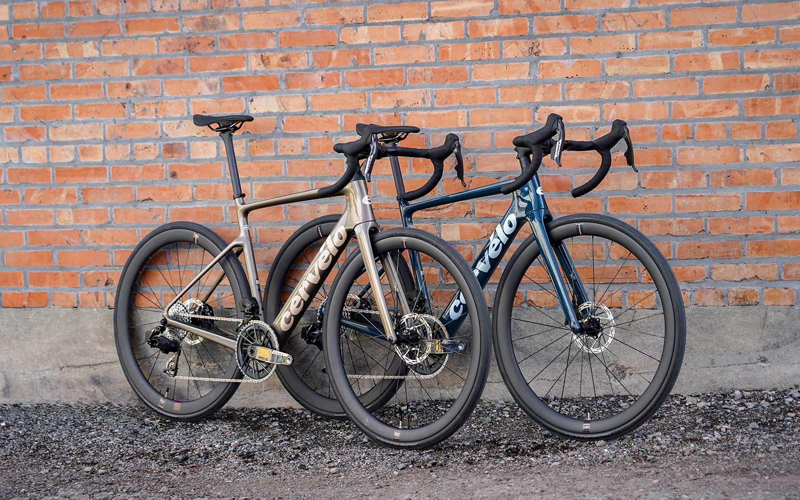 Two Cervelo Caledonias leaned up against a brick wall.