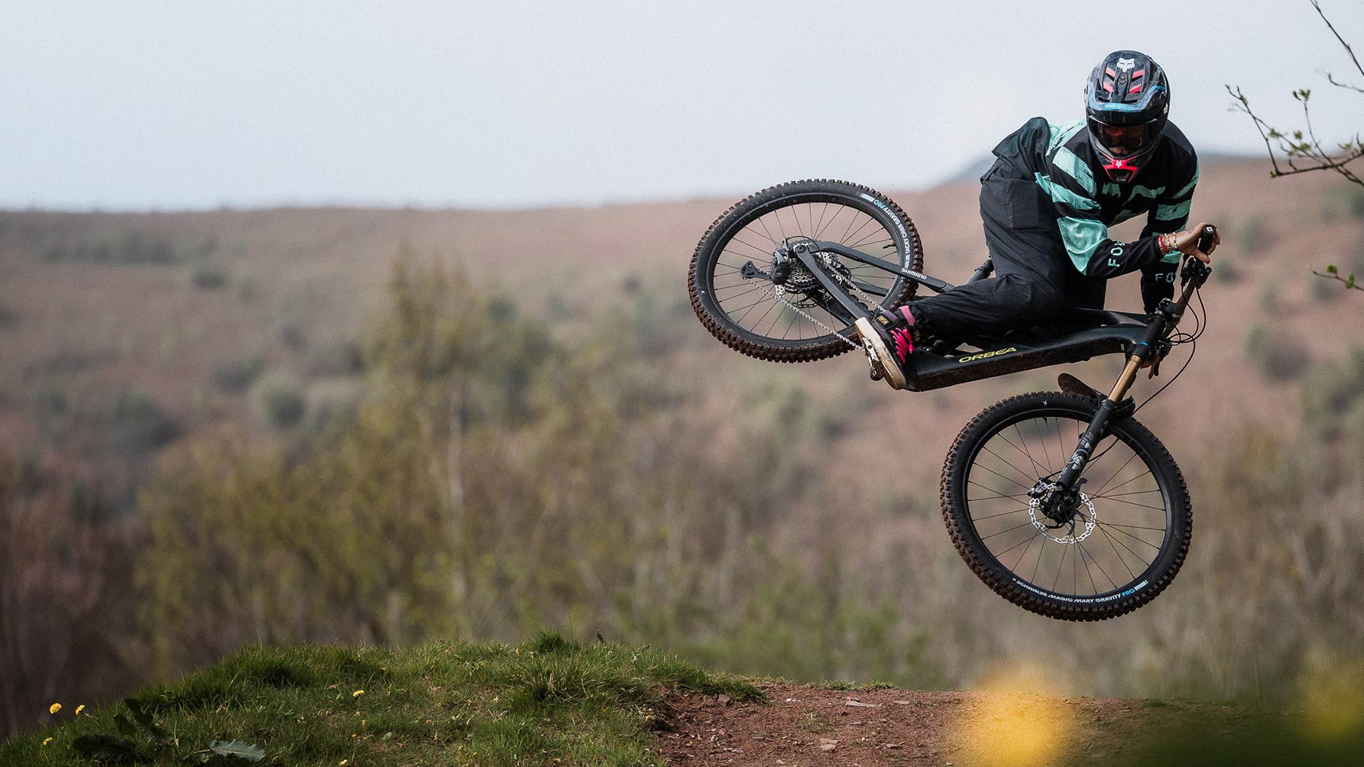 Cyclist doing a whip on a Orbea Wild LT.