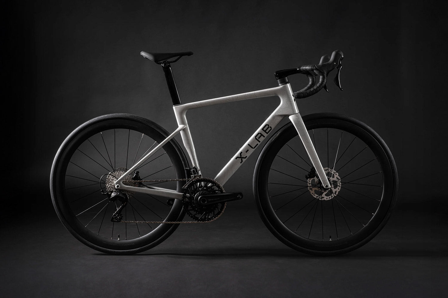 White bicycle with black components on a dark background