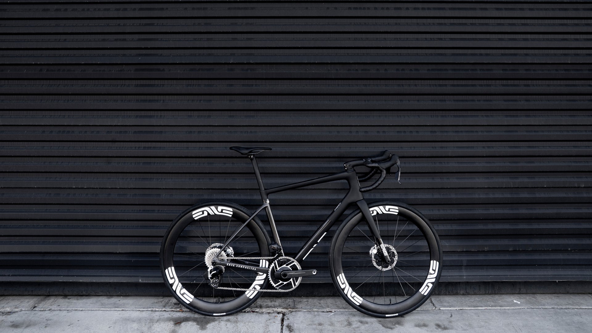 The Black enve fray all road bike against a black wall