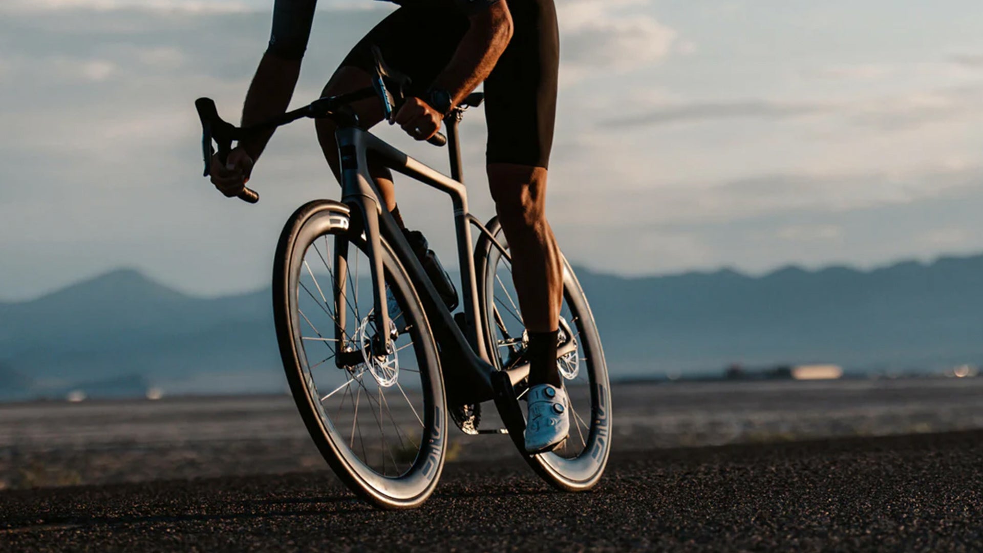 a man riding an enve melee road bike on flat ground