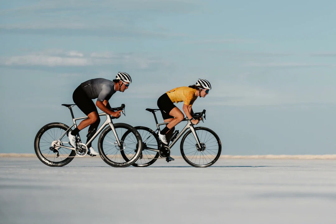 Two people riding ENVE road bikes on the Salt flats. 