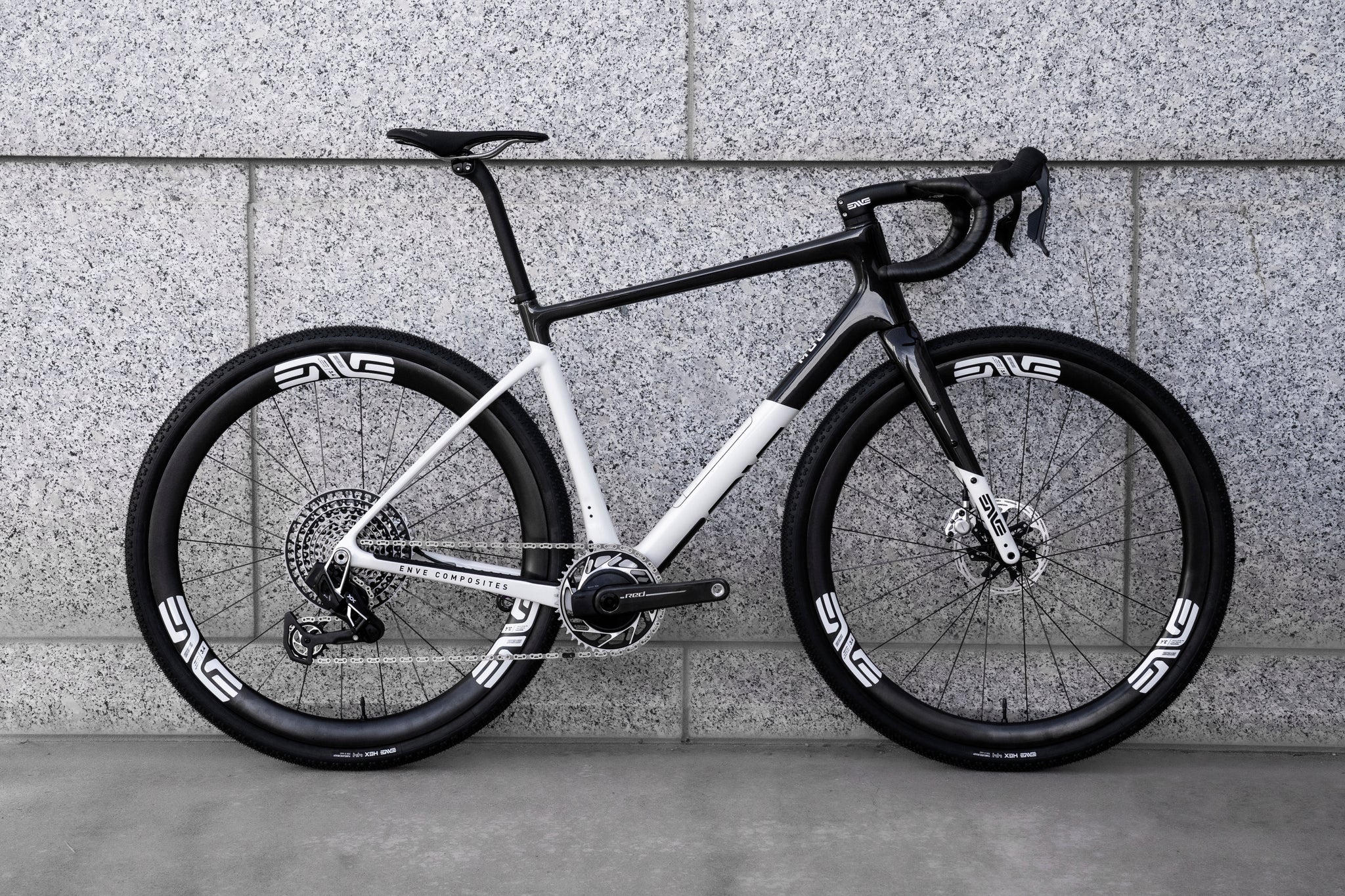 a black and white enve mog gravel bike photographed against a cement wall. 