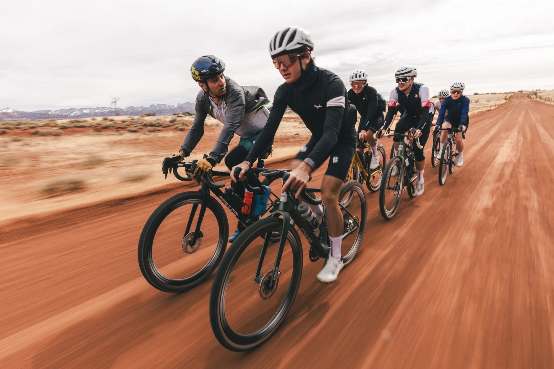 a Group of people riding the enve mog gravel bike on a dirt road