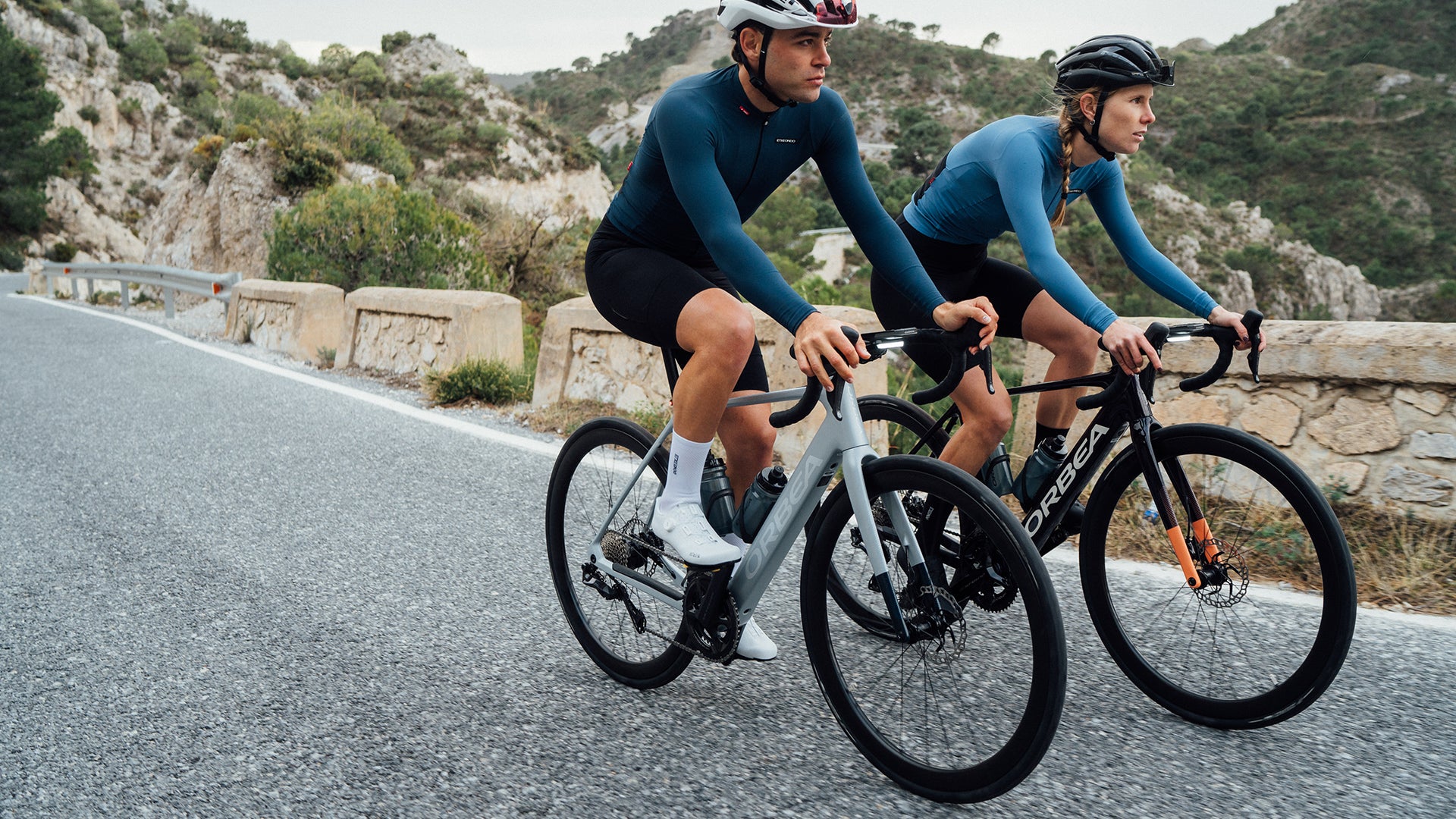 Two peoplle riding the The orbea gain E bike, on the top of a mountain. 