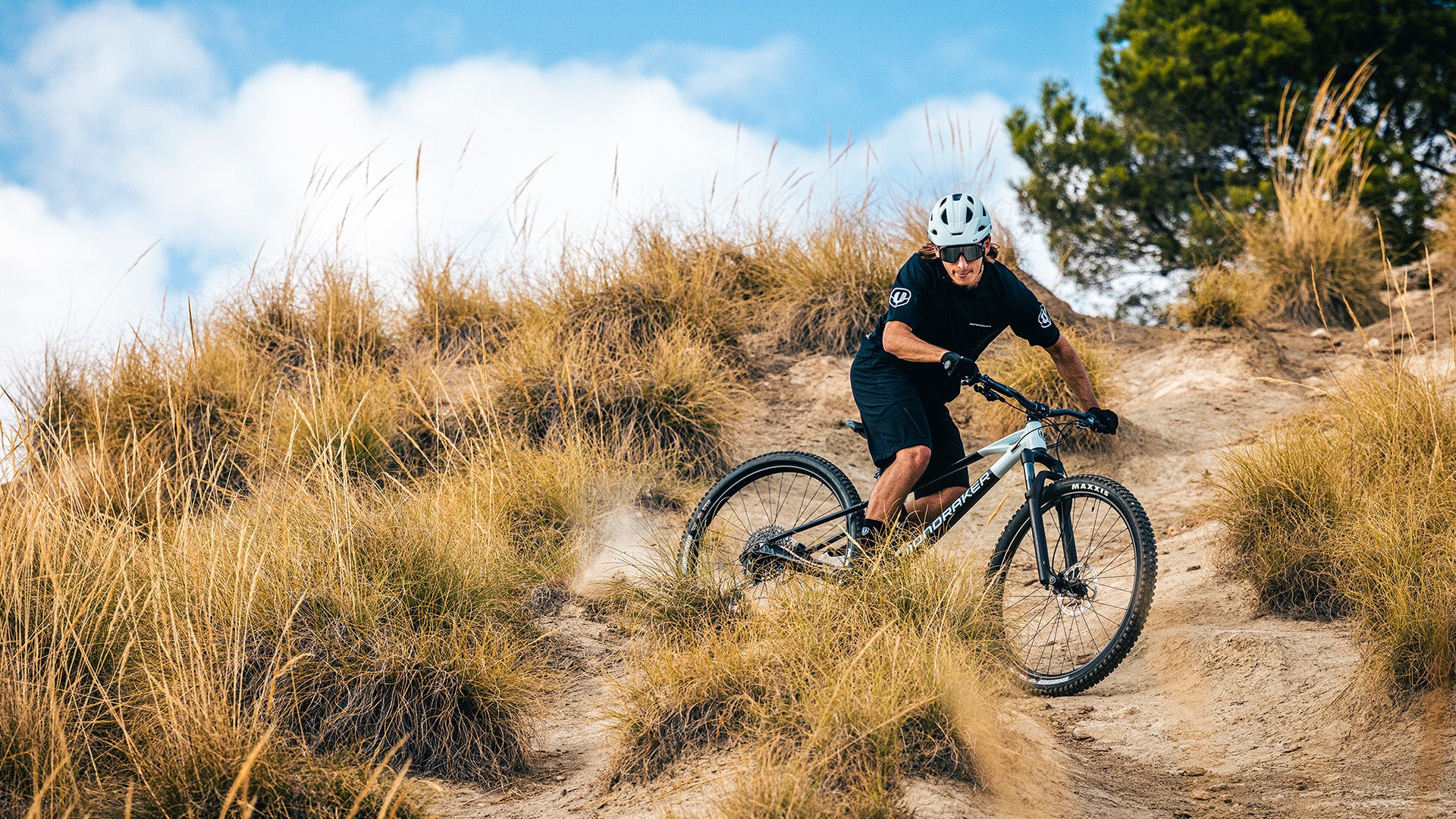 People riding mondraker bikes in a desert.