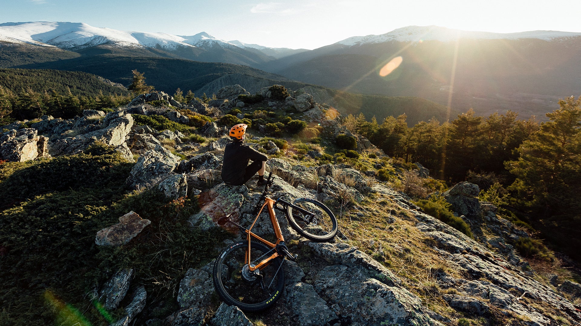 a man riding an orbea Urrun electric bike up a mountain.