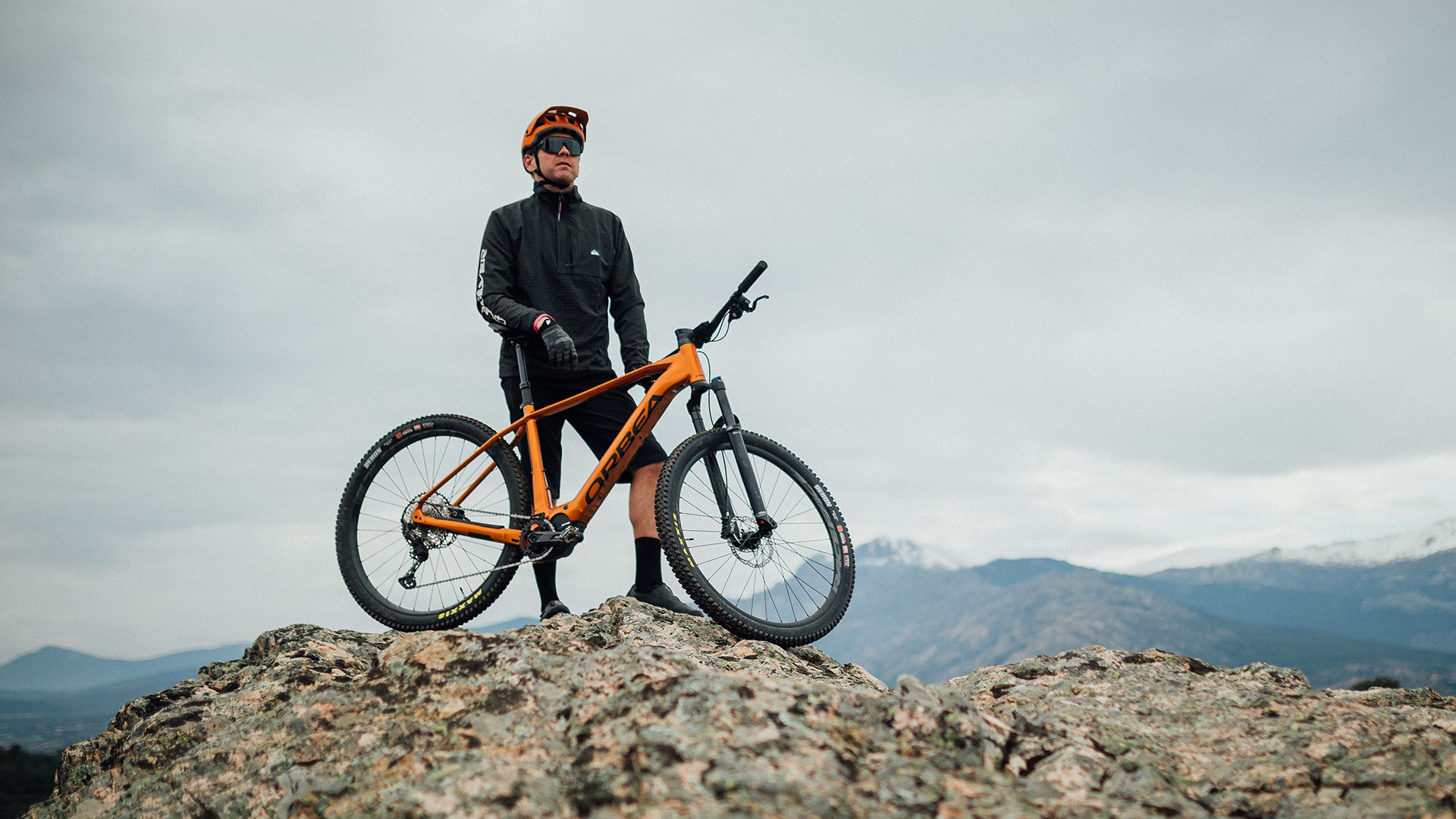 a man riding an Orbea Urrun electric bike up a mountain.