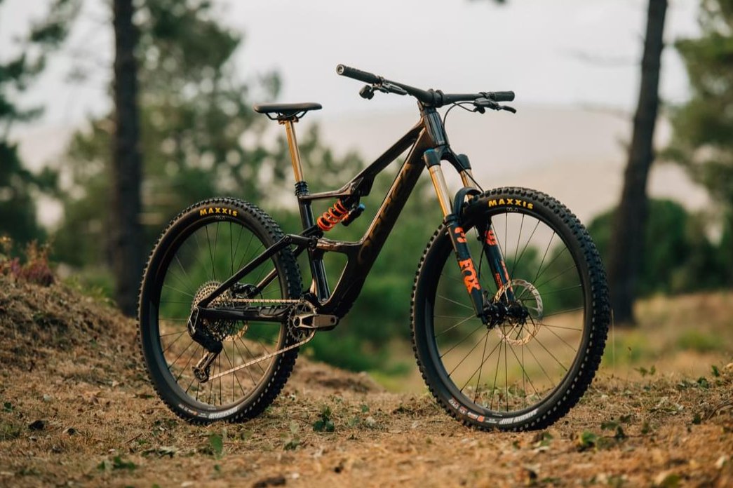 An Orbea Occam Mountain bike staged in a forest clearing.