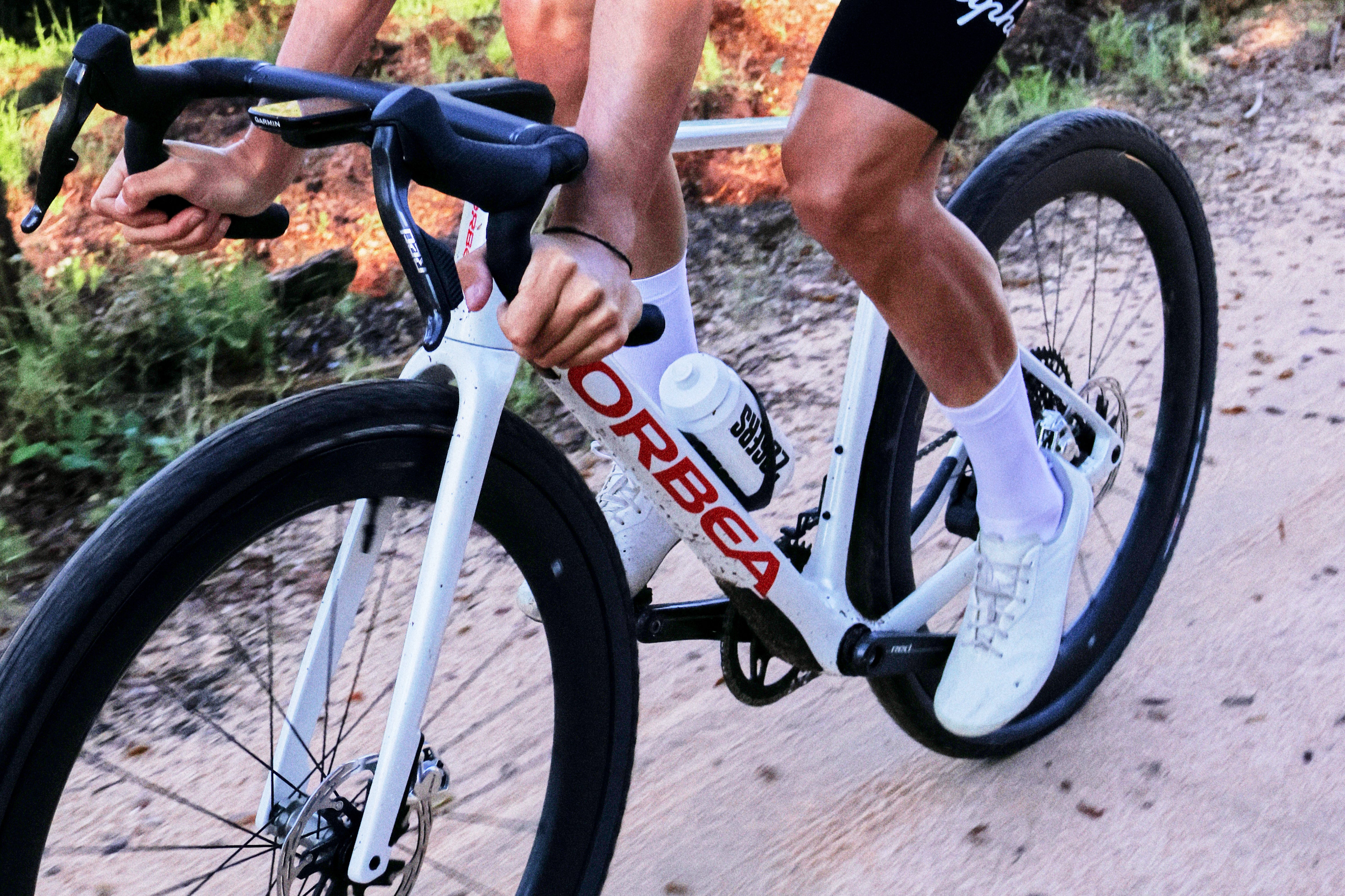 The Orbea Terra Race gravel bike being ridden on a dirt road.