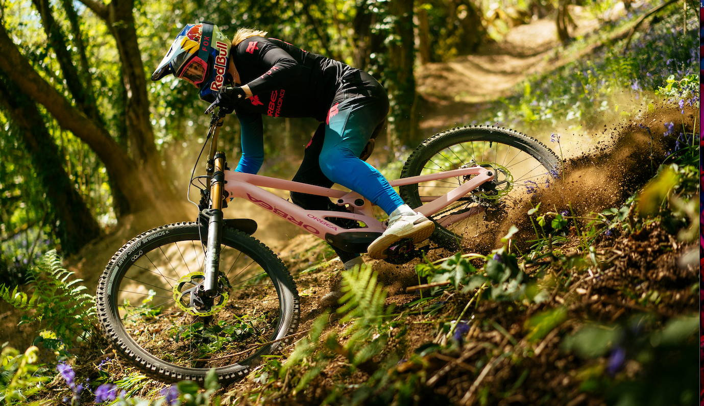 A woman riding a bike orbea downhill mountain bike