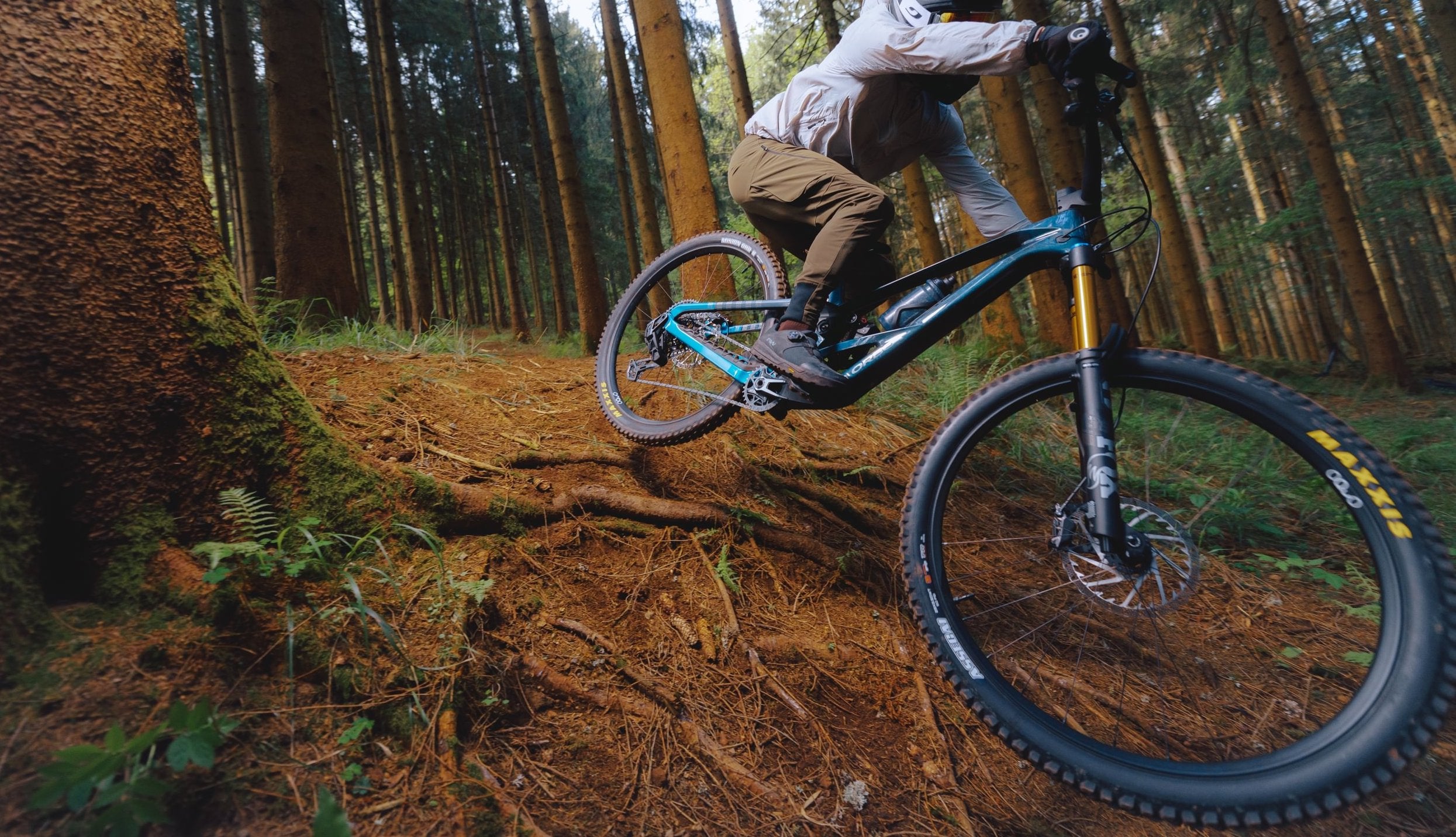 The Orbea Rallon Mountain bike, being ridden in the forest. 