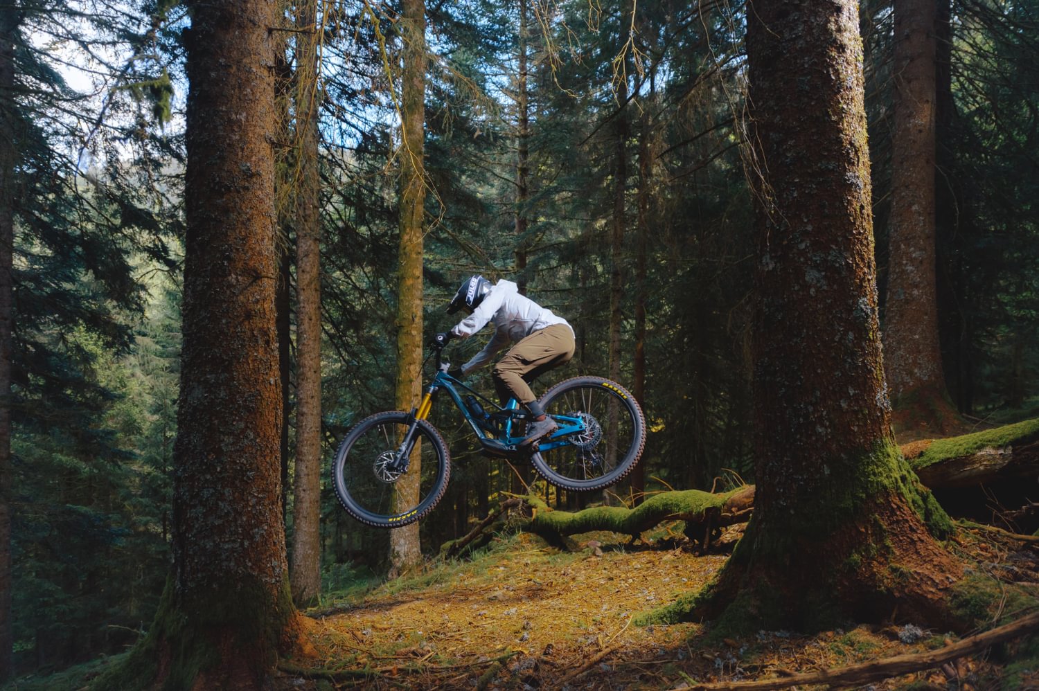 The Orbea Rallon being ridden through a forest, available at Contender Bicycles.