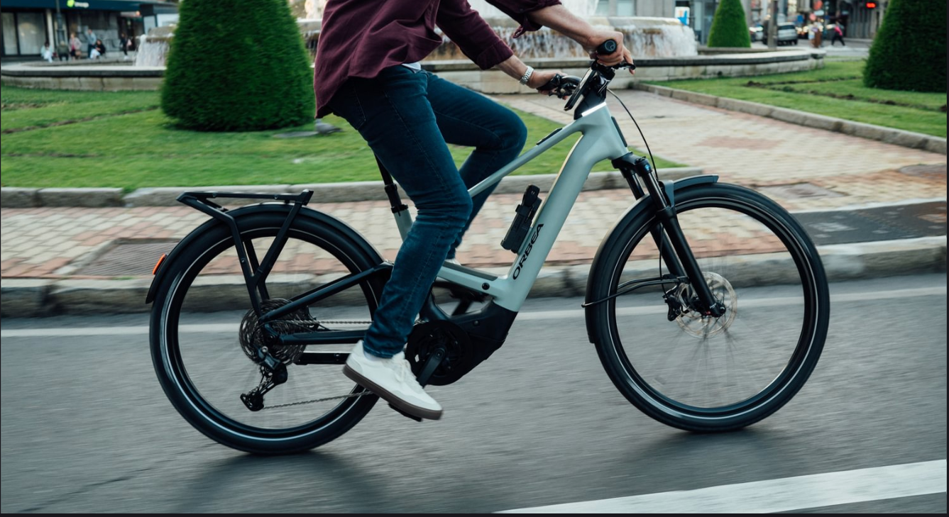 A man riding the orbea Muga electric bike in a European roundabout