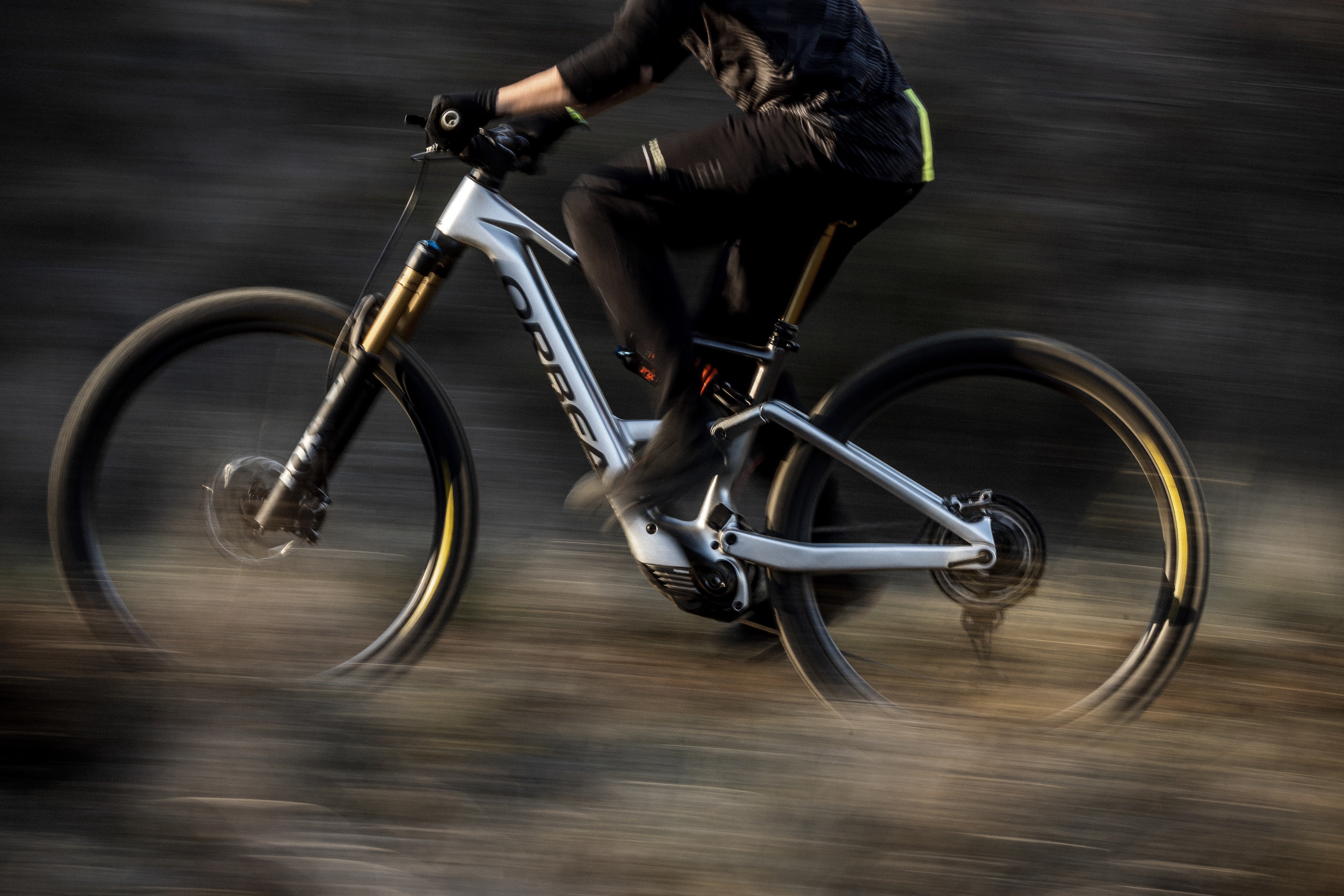 A man riding the orbea rise electric bike