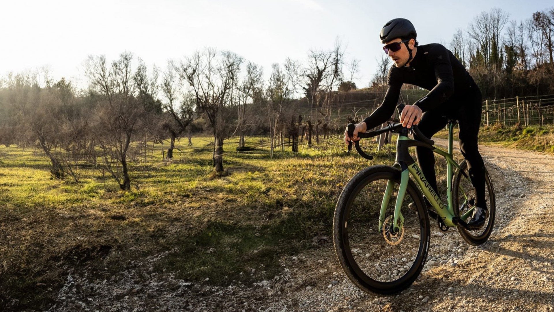 A man riding the pinarello Grevil F gravel bike in a vineyard