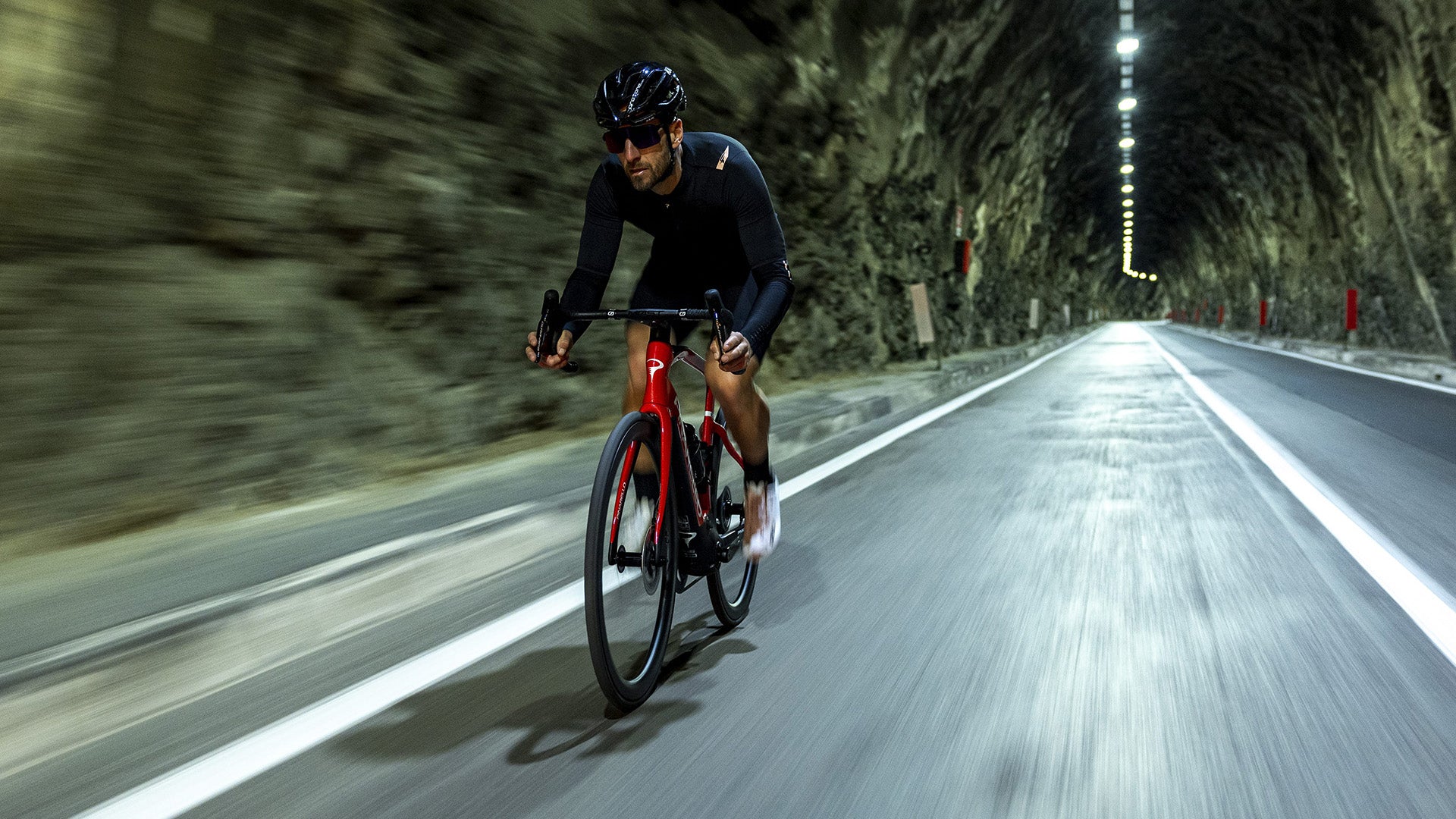 A Man riding the Pinarello nytro road Electric Road in a tunnel 