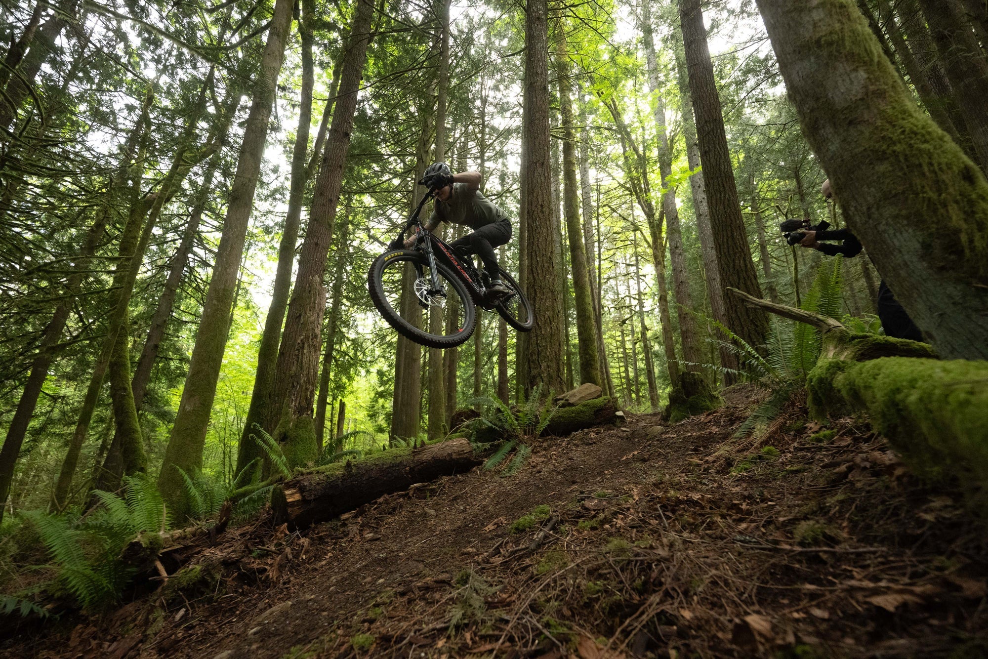 a man riding the Santa Cruz Vala Ebike through a forest. 