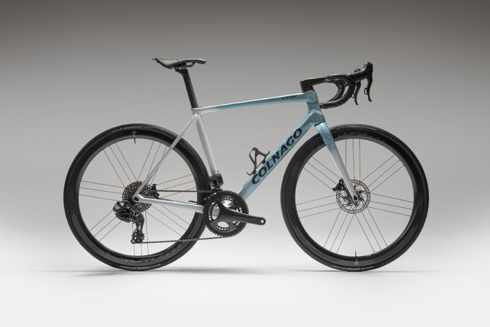 A blue and white Colnago C68 on a white and gray background.