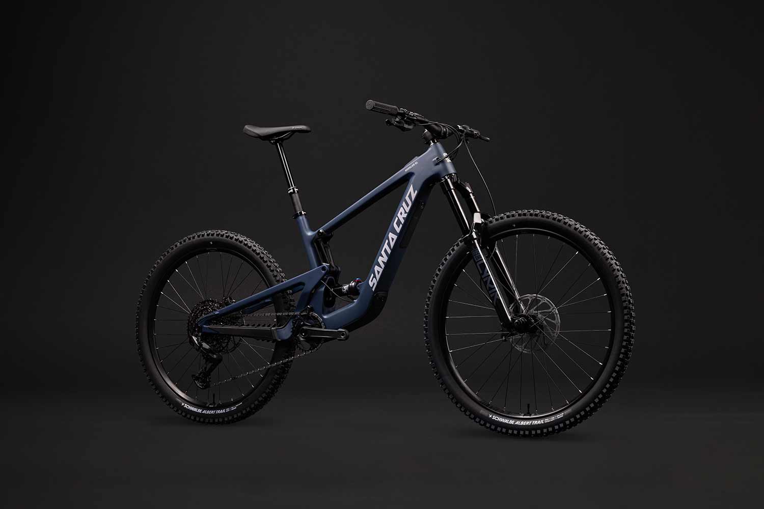 Blue Santa Cruz Heckler SL in front of grey background.