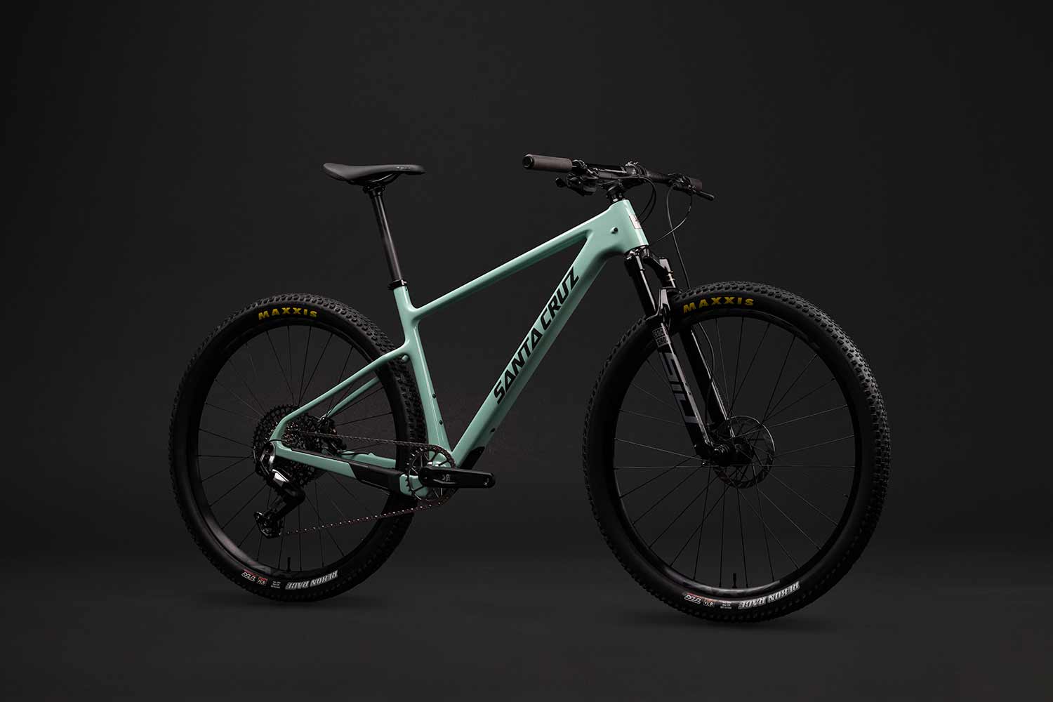 Turquoise Santa Cruz Highball in front of a grey background.