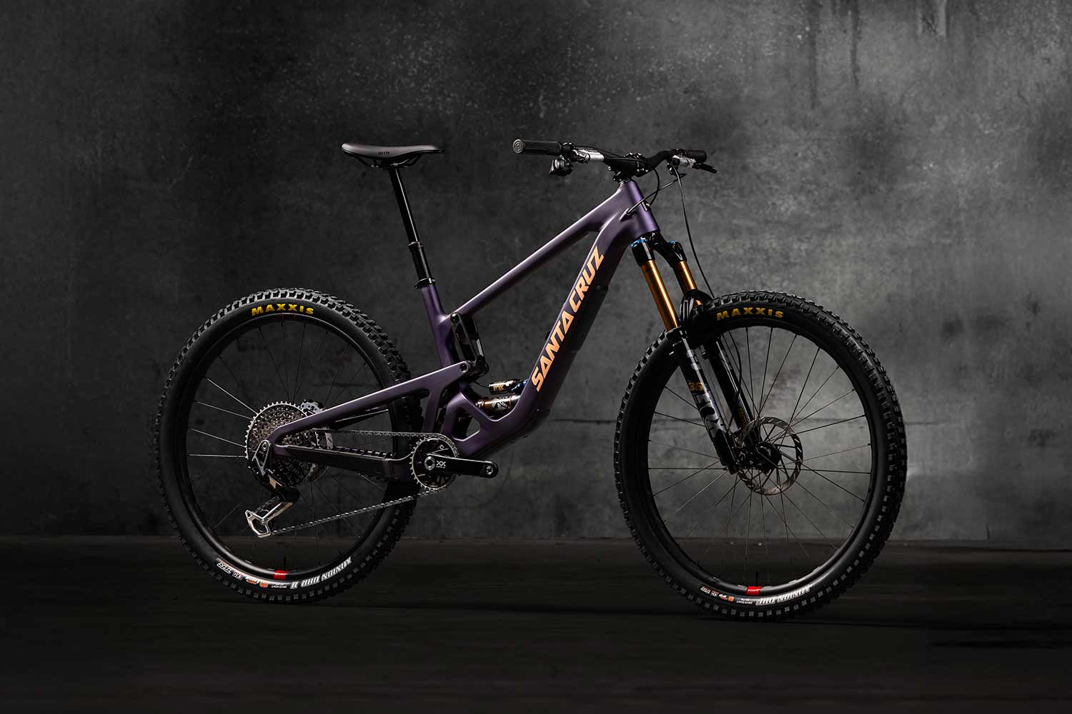 Purple Santa Cruz Hightower in front of grey wall.