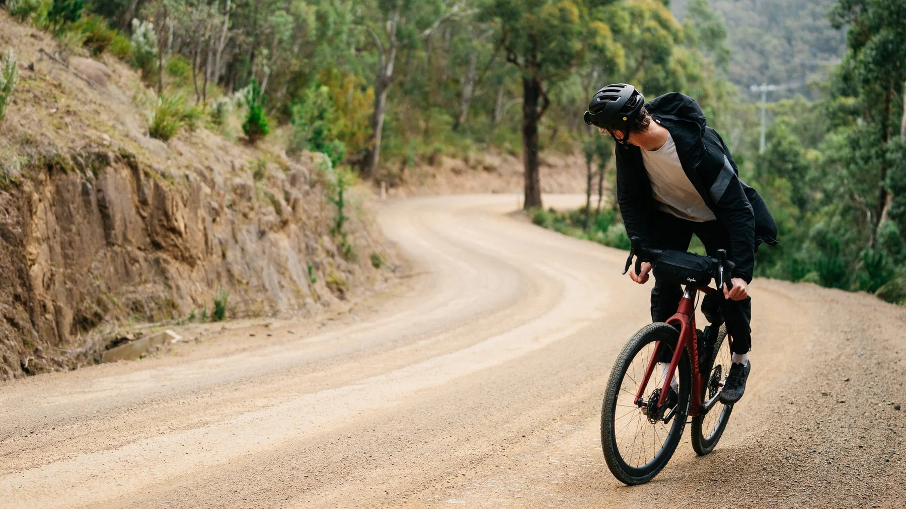 A man riding a santa cruz stigmata gravel bike on a dirt roads