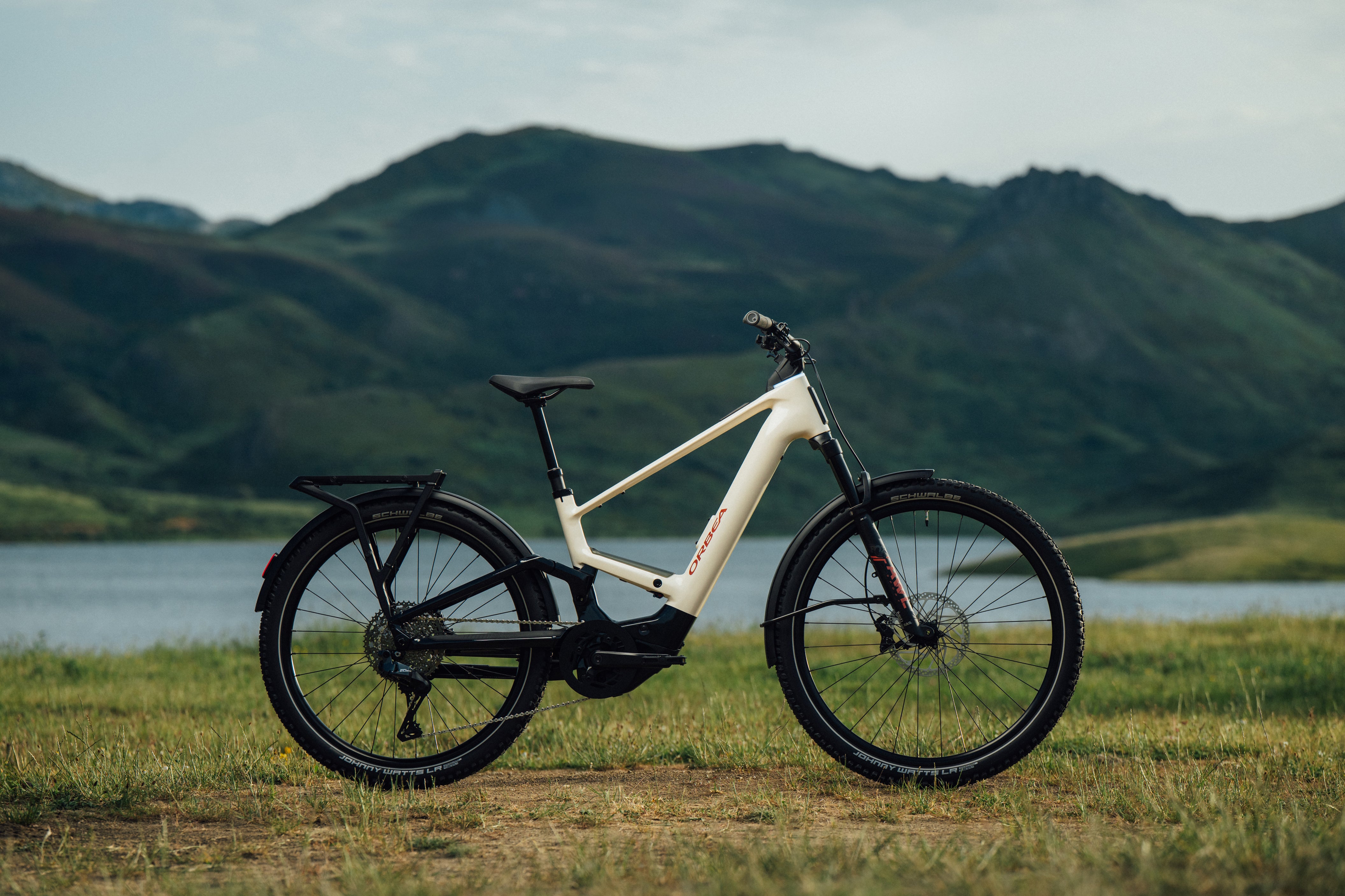The orbea Muga Electric Bike staged in front of a Mountain range. 