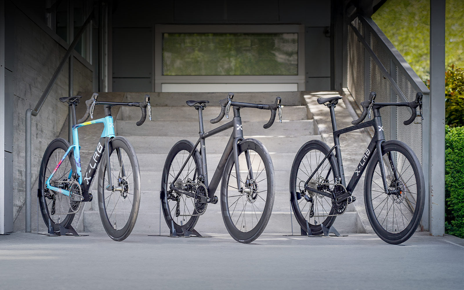 Three X-Lab bikes staged in front of Contender Bicycles.