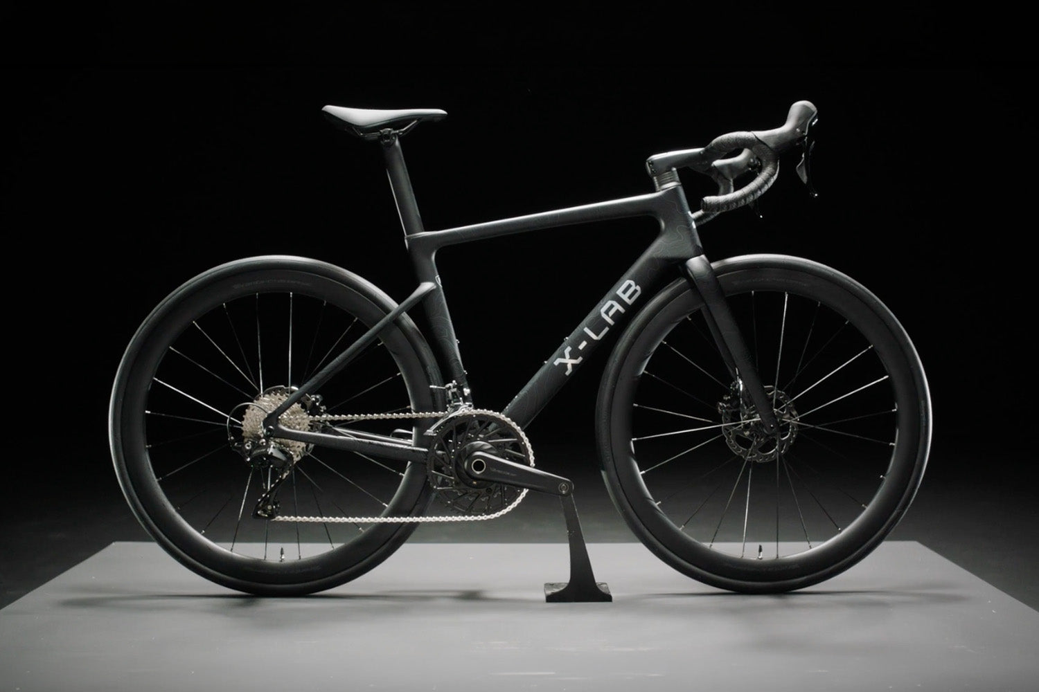 Black bicycle with 'X-Lab' branding on a dark background