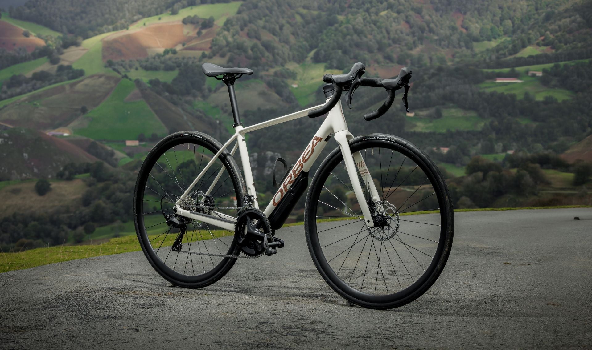 A picture of the Orbea Avant Road bike, with a the countryside in the background.