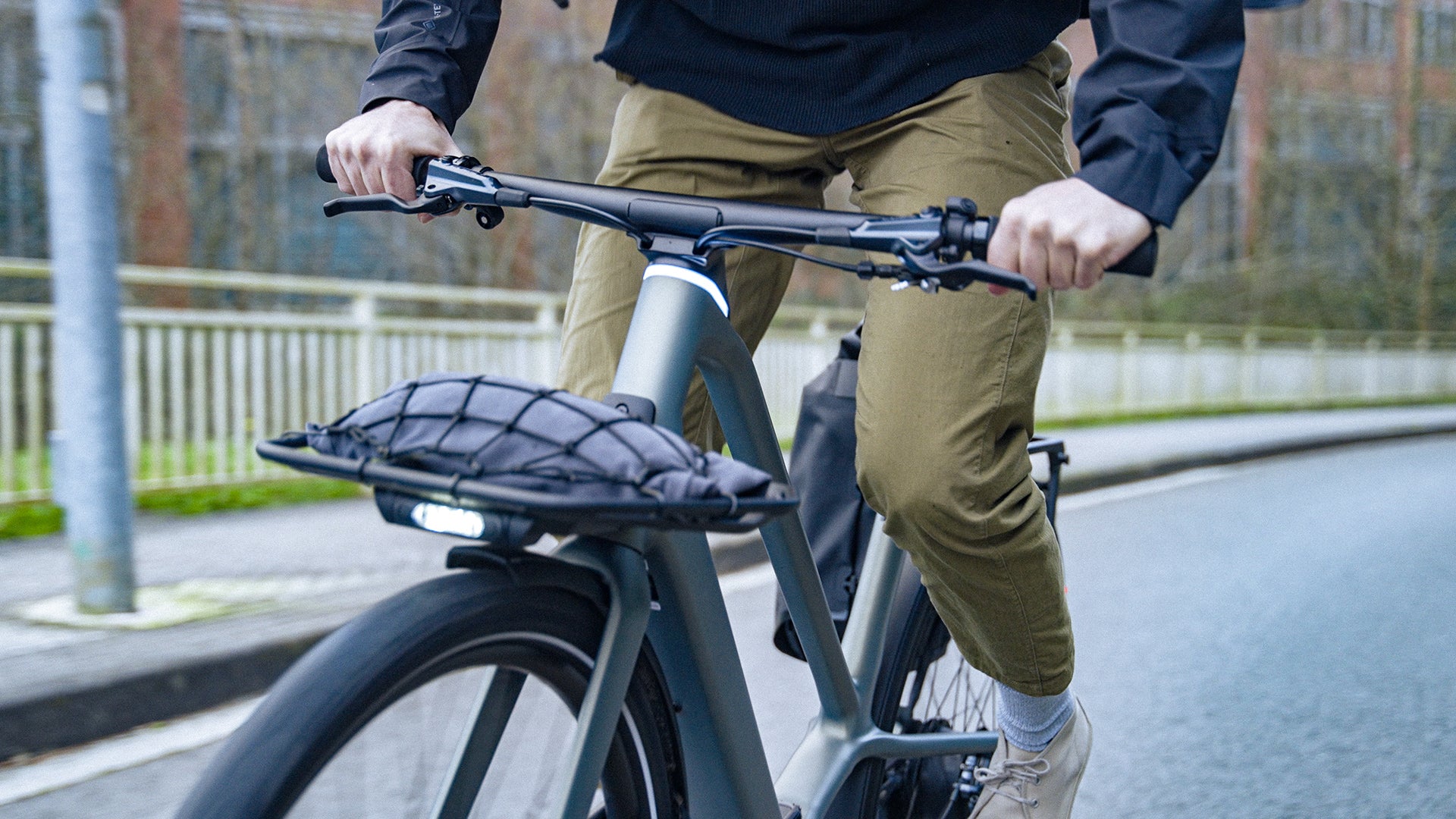 a man riding an Orbea Diem electric bike in a city.