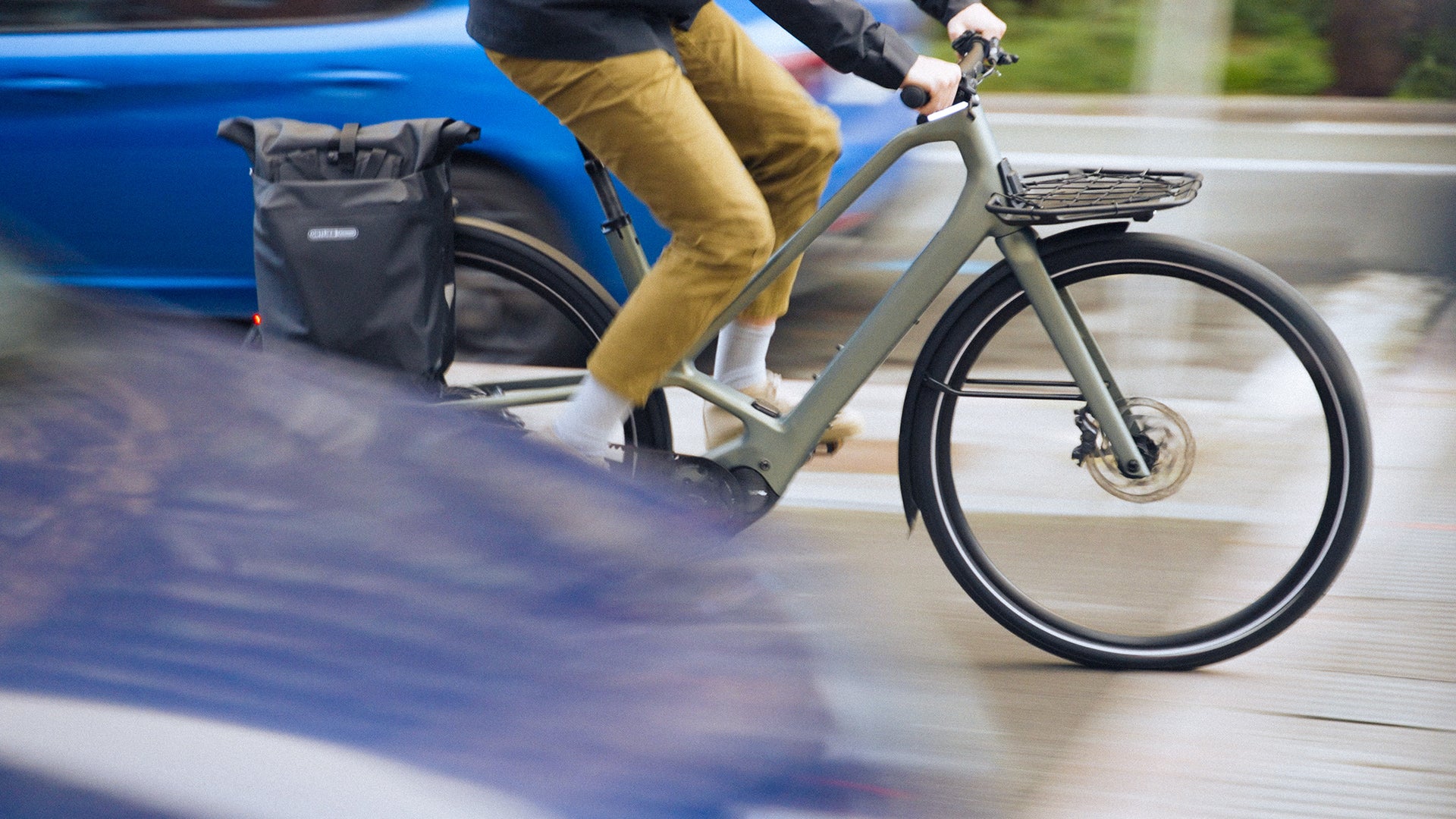 a man riding an Orbea Diem electric bike in a city.