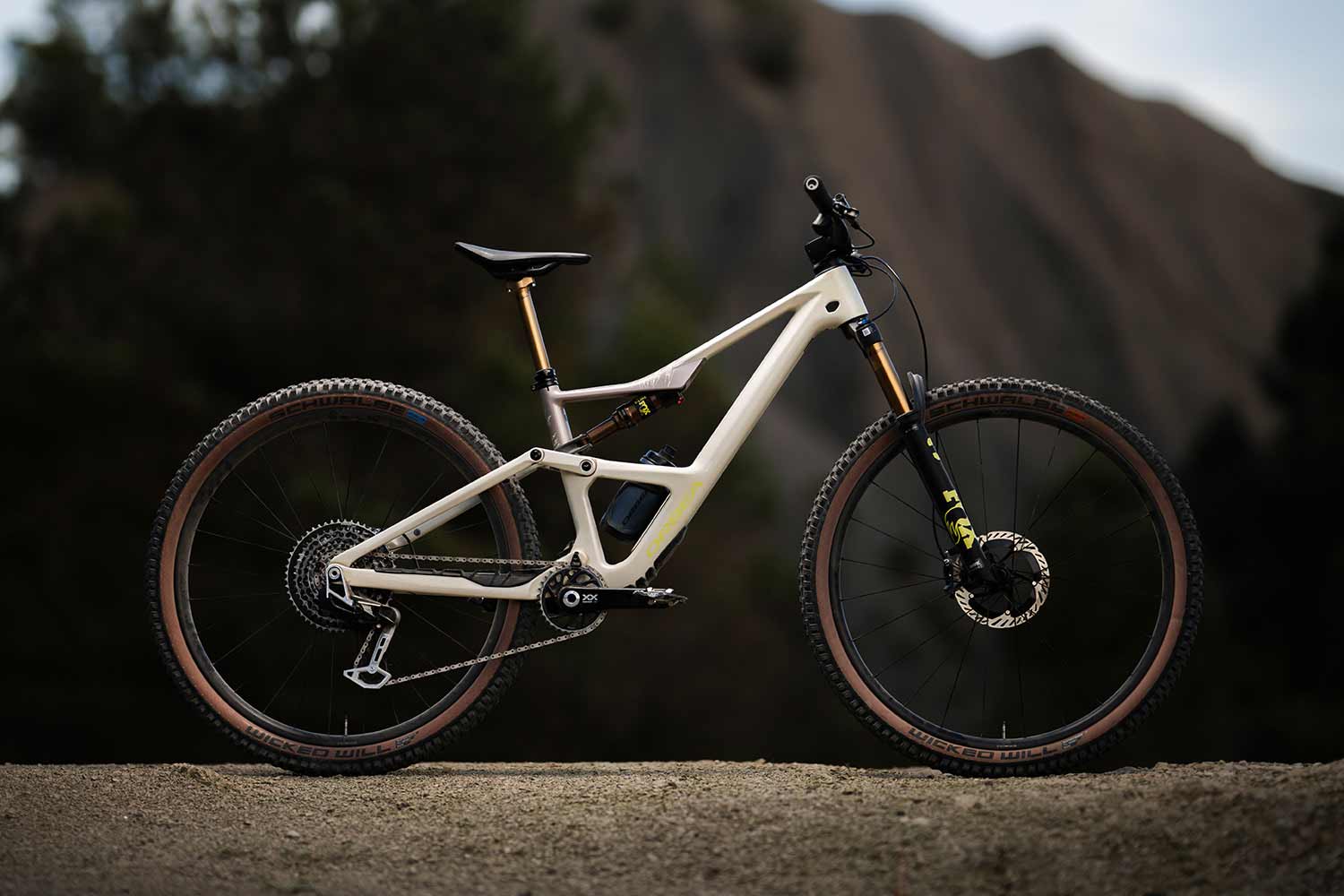 Mountain bike on a dirt path with a mountainous background.