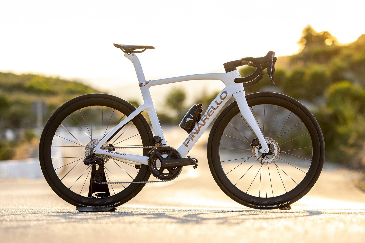 A detailed shot of the Pinarello F Road bike against a sunset.